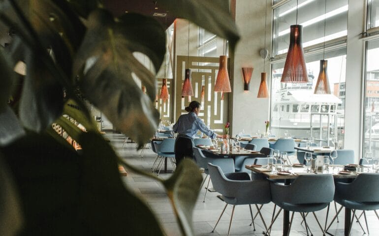 Hospitality staff setting up tables.